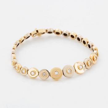 A 14K gold bracelet set with round brilliant-cut diamonds.