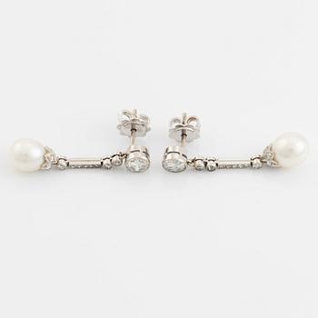 A pair of platinum pearl earings.