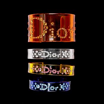 A set of four plexiglass bracelets in different colours by Christian Dior.