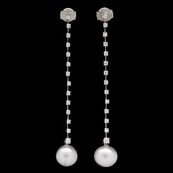 A pair of cultured South sea pearl and brilliant cut diamond earrings, tot. 0.60 cts.