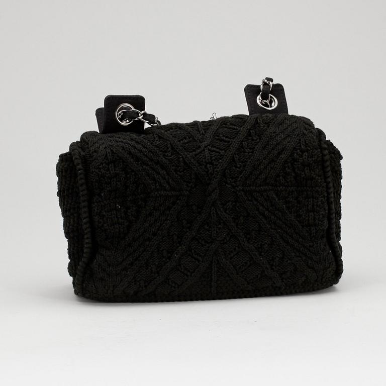 CHANEL, a black crochet flap evening shoulder bag.