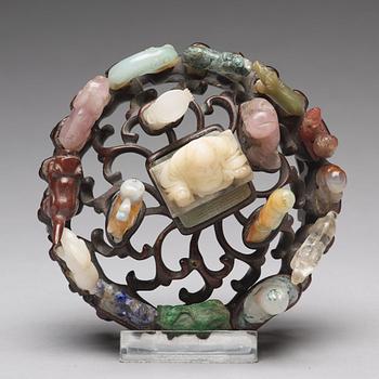 An arrangement of stone sculptures on a wooden stand, China 20th Century.