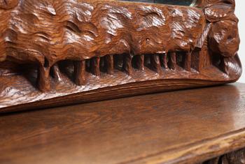 An Art Nouveau oak wall mirror with a console table.