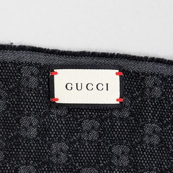 Gucci, A 'Verbier' scarf and a belt.