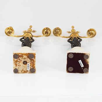 A pair of French Louis XVI ormolu, marble, and patinated bronze two-branch candelabra, late 18th century.