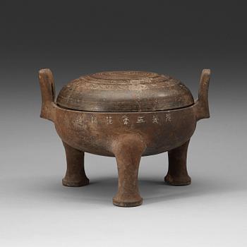 A pottery tripod censer, Han dynasty (206 B.C. -220 A.D.).