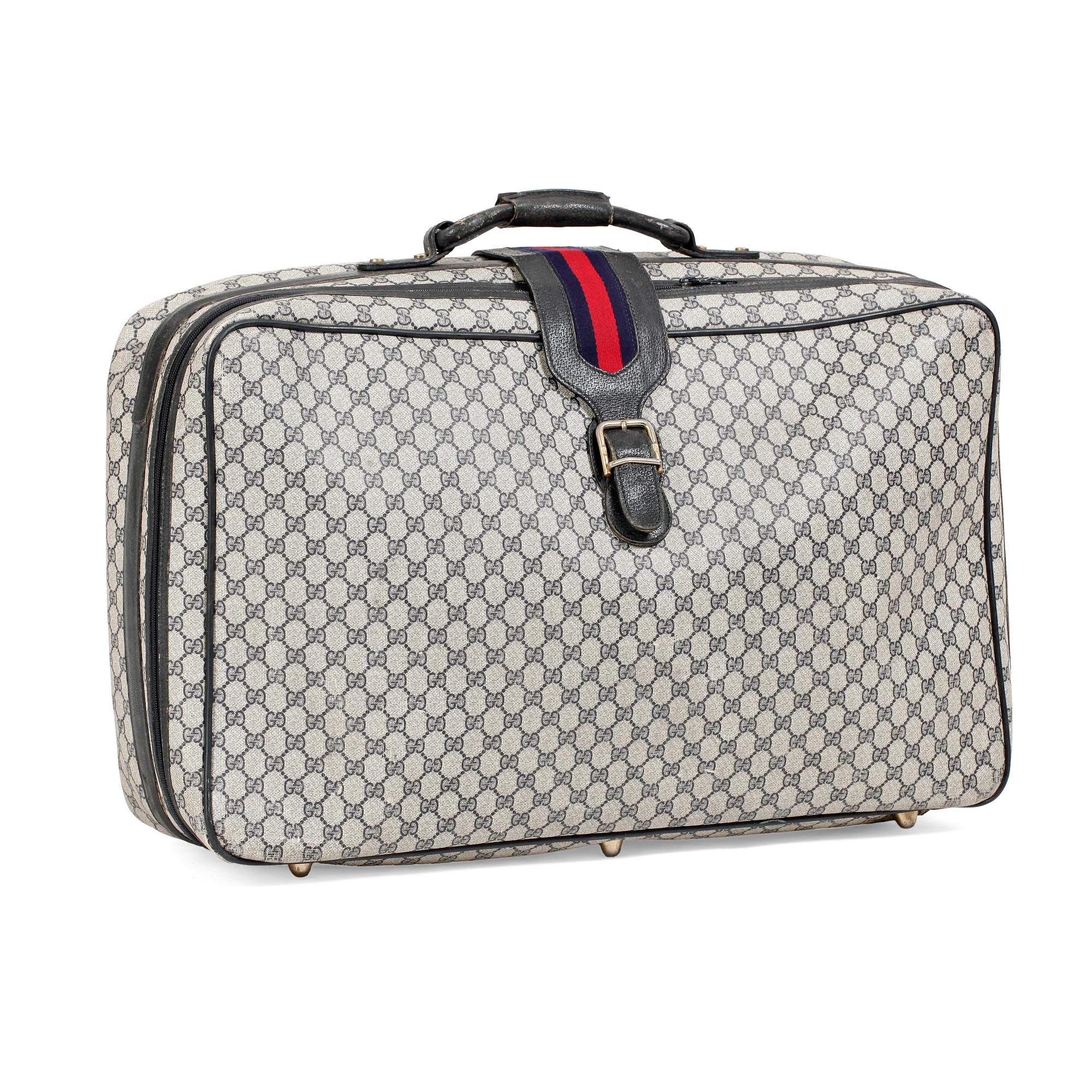 GUCCI, a blue monogram canvas suitcase.