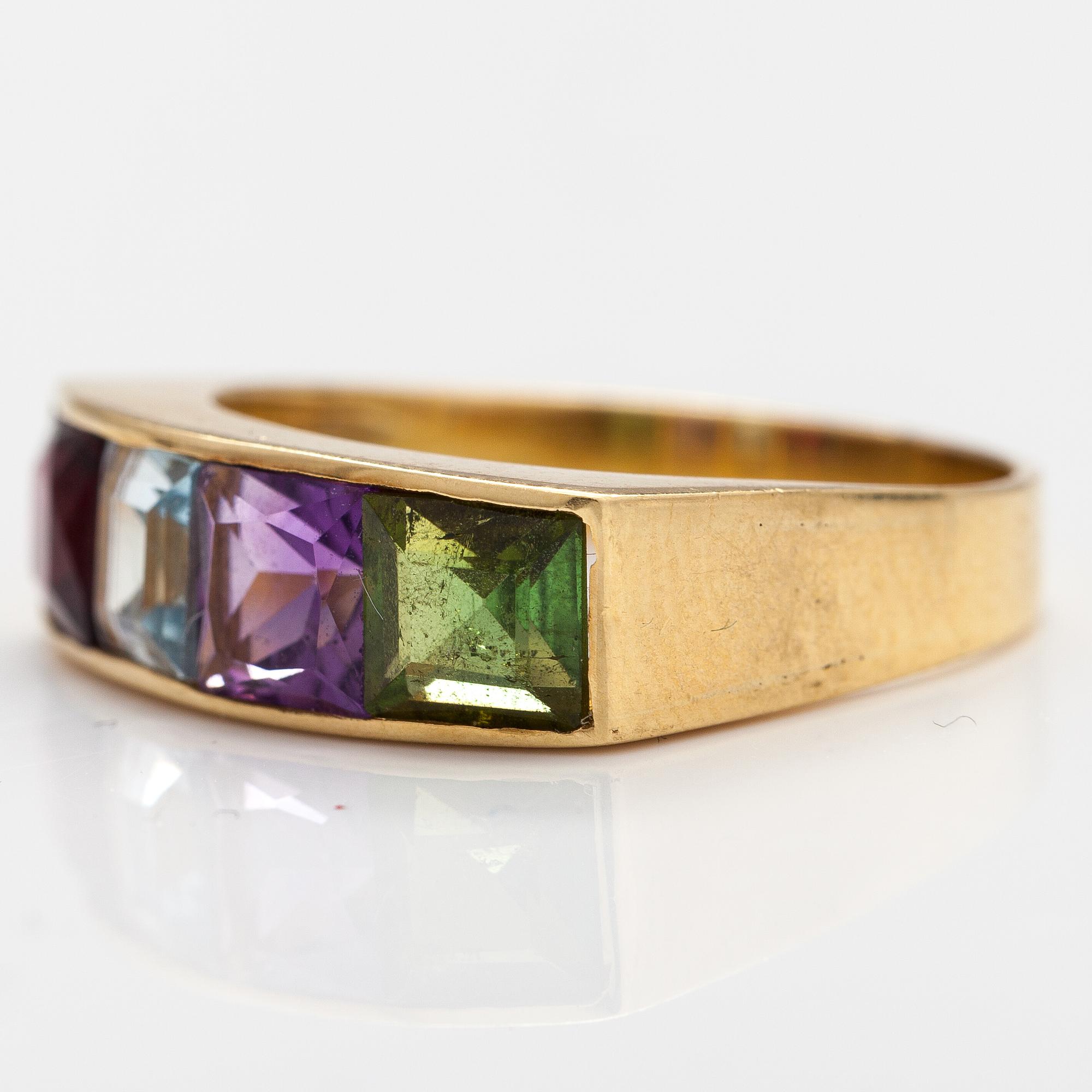 An 18K gold ring with an amethyst, garnet, topaz and peridote.