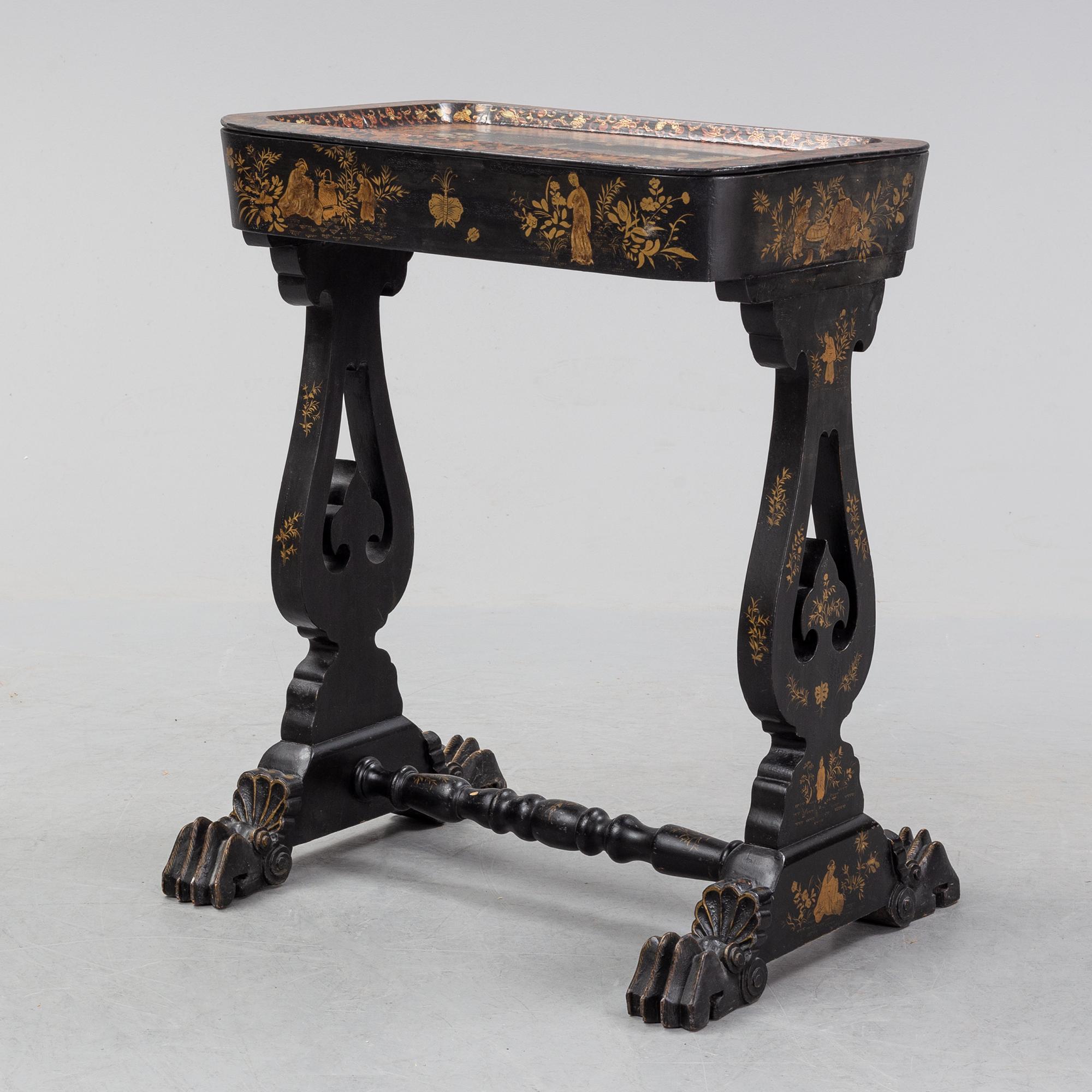 A black chinoiserie sewing table, second half of the 19th Century.