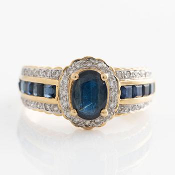 Ring in gold with dark sapphires and brilliant-cut diamonds.