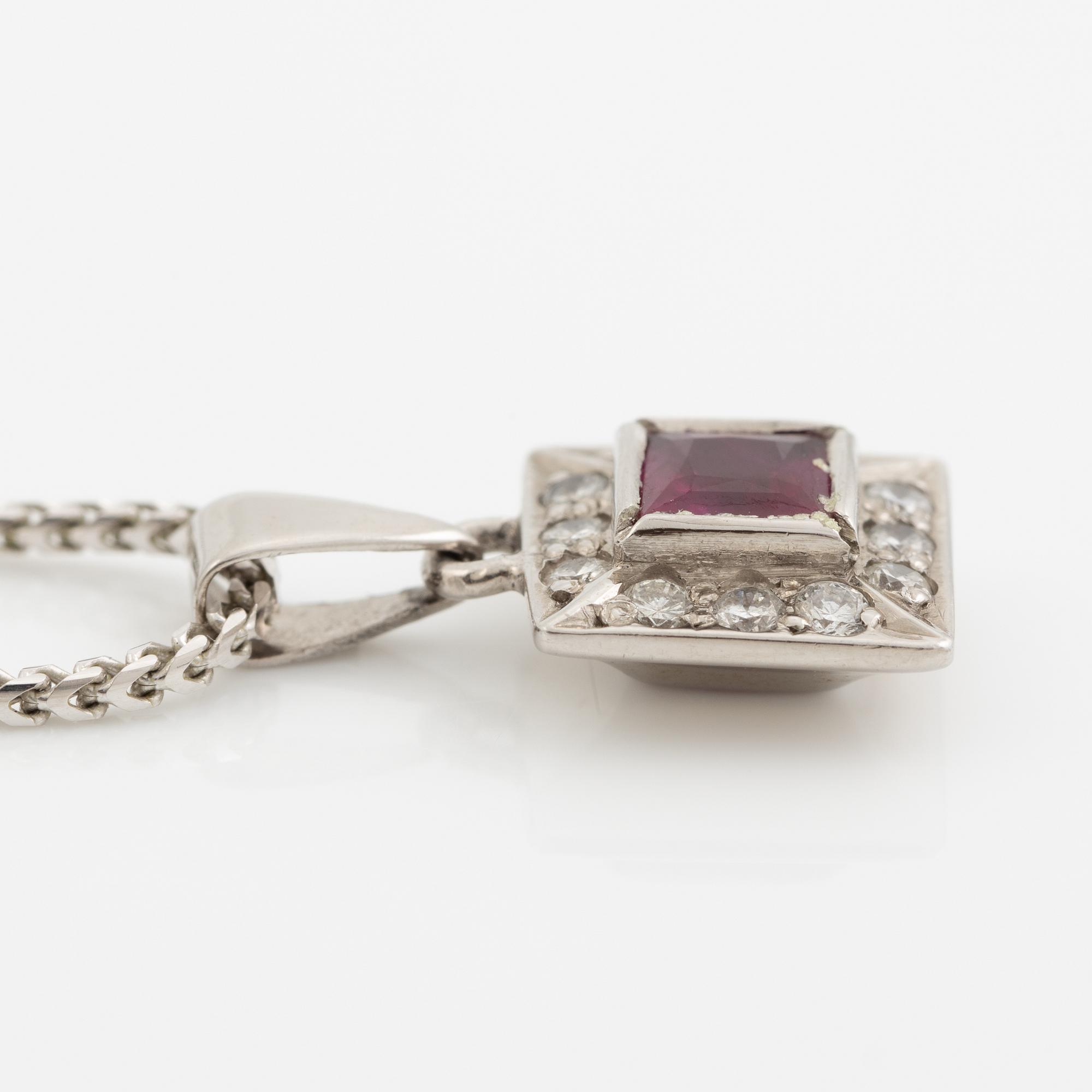 Pendant with chain in 18K white gold featuring a red stone, likely a ruby, and diamonds.