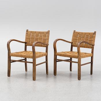 A pair of stained beech armchairs, first half of the 20th Century.