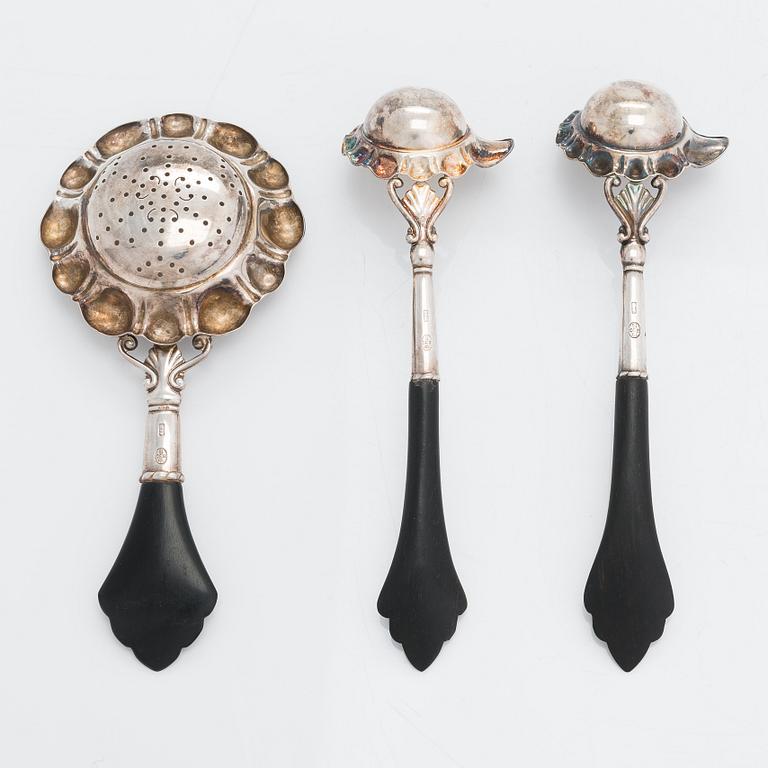 A Cohr silver tea strainer and a pair of silver  ladles for clarified butter, Denmark, Swedish importmarks. Around 1940.