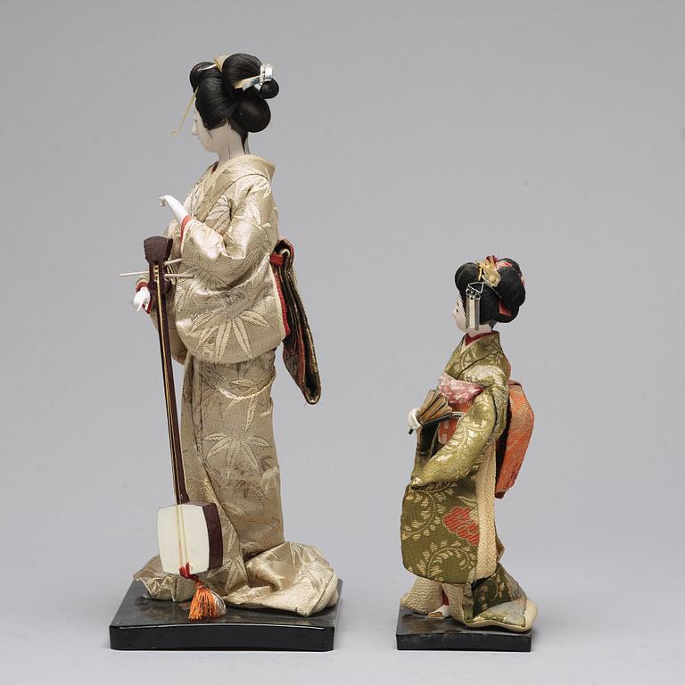 Two Japanese dolls and a box with minitures, 20th Century.