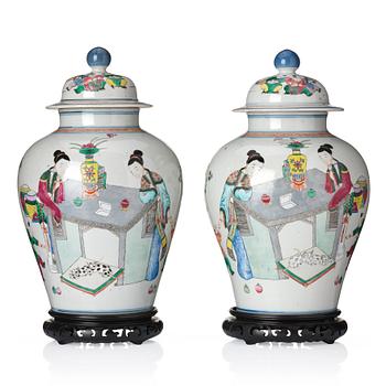 1277. A pair of famille rose 'ladies and boys' vases with covers, late Qing dynasty.