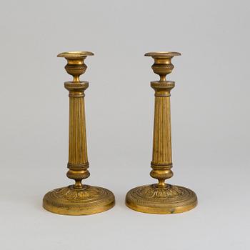 A pair of French gilt bronze Empire candlesticks, first half of the 19th Century.