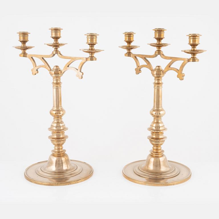 A pair of brass candelabra, early 20th Century.