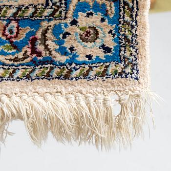 A oriental signed Nain silk carpet. Circa 267x163 cm.