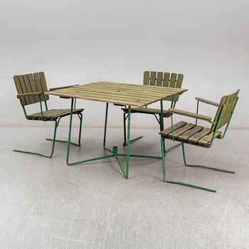 Three Arbrå stålmöbler and Grythyttan garden armchairs and a table, mid 20th century.