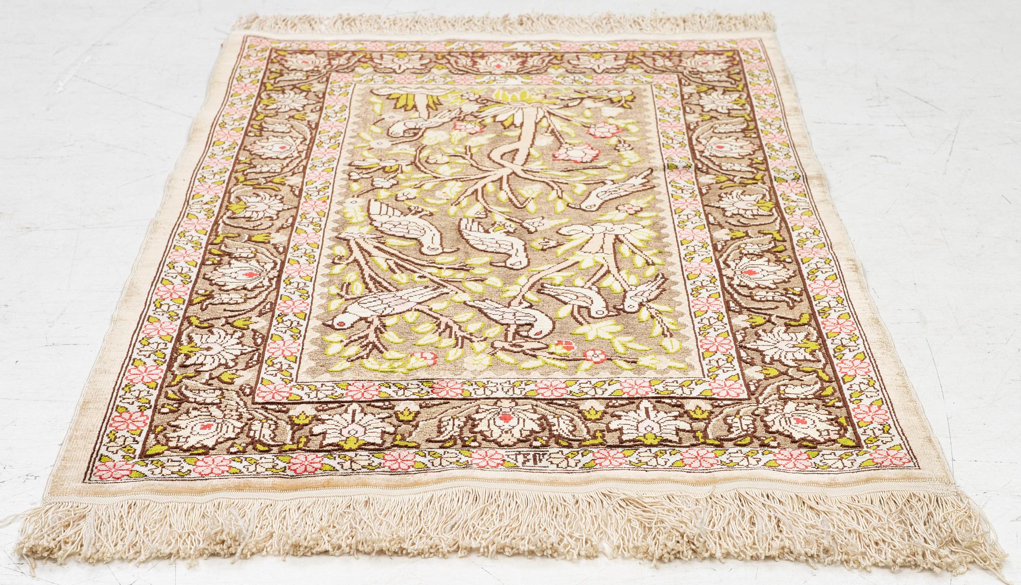 A silk an metal Hereke rug, West Anatolia, c. 100 x 68 cm.