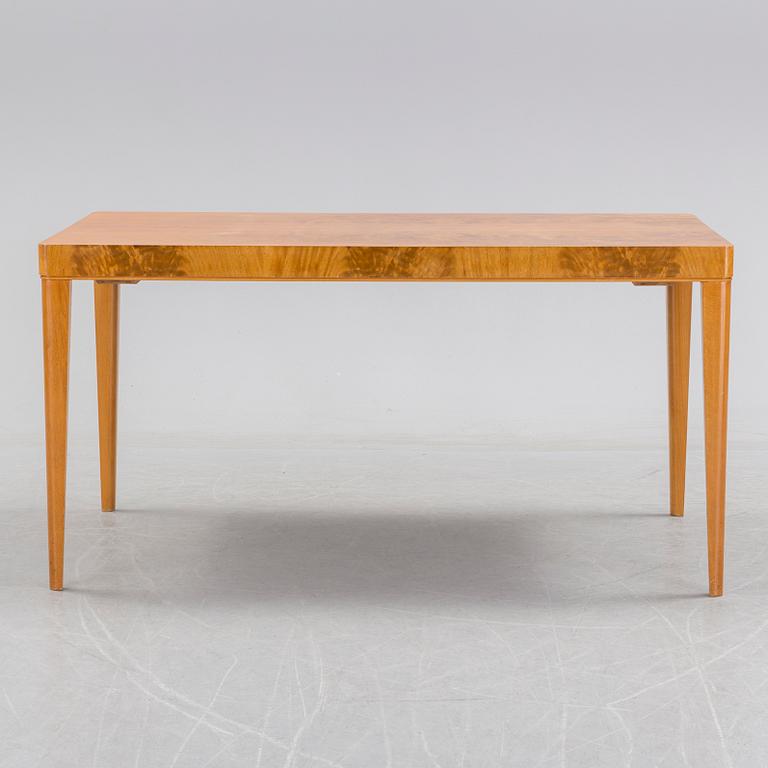 A 1940's dining table an four chairs.