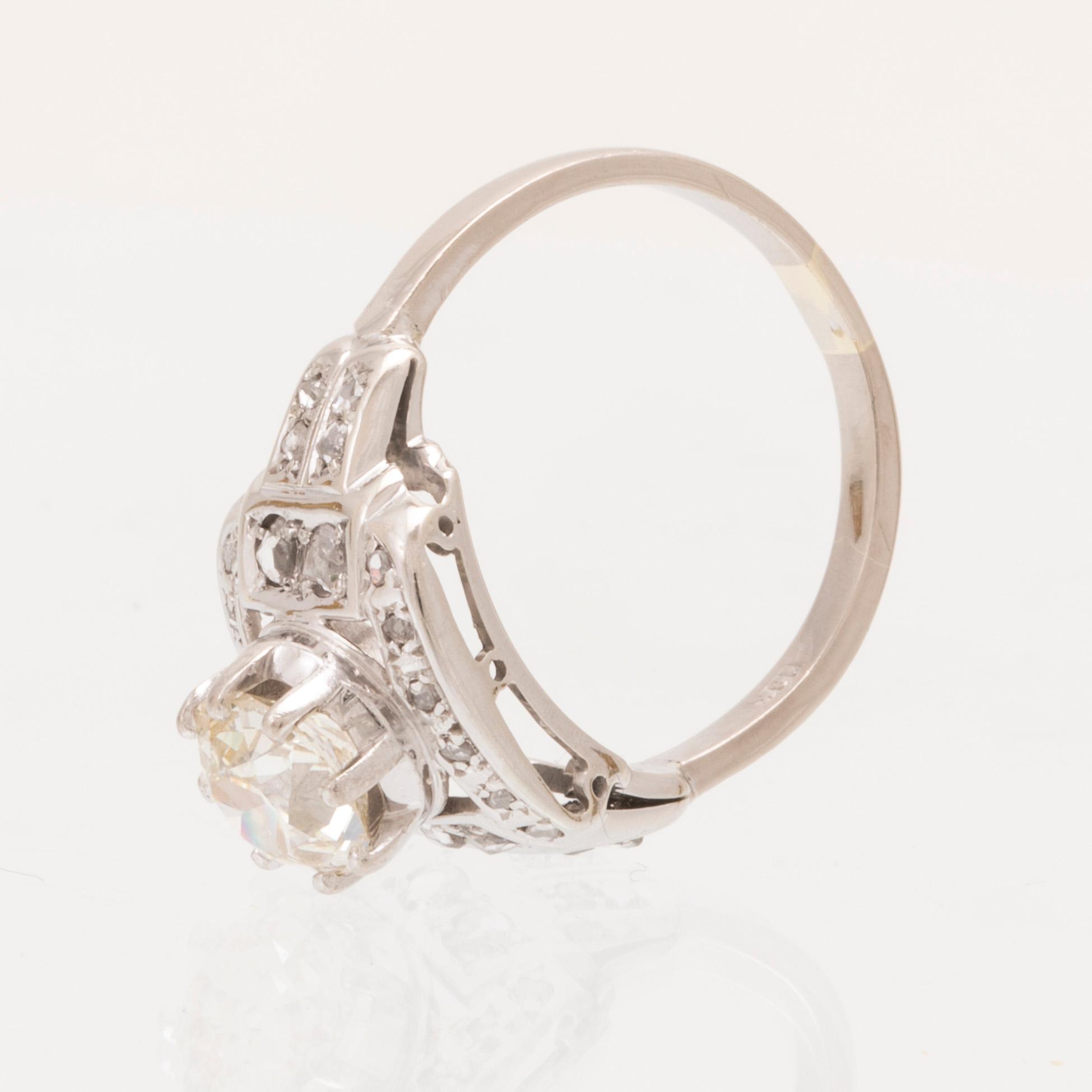 An 18K white gold ring set with an old cut diamond and rose cut diamonds.