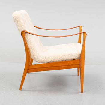 Ebbe & Karen Clemmensen, an armchair/safari chair model 4305, with sheepskin, Fritz Hansen, model designed in 1958.