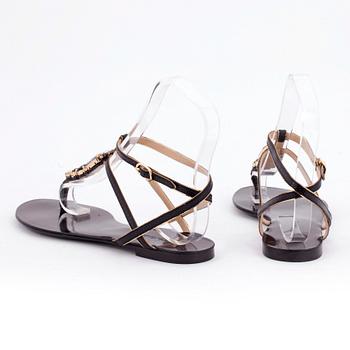 DOLCE & GABBANA, a pair of black leather sandals.