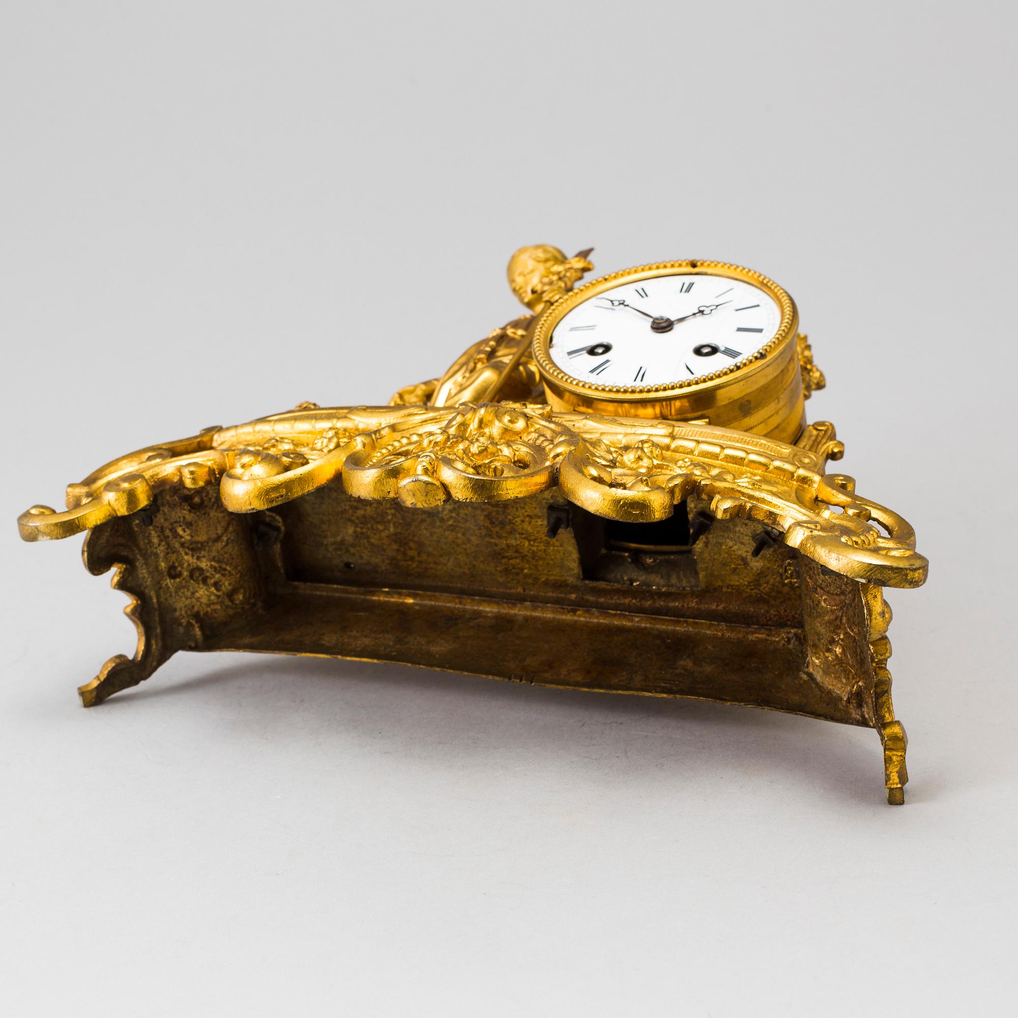 A LATE 19TH CENTURY GILT METAL MANTLE CLOCK in the Rococo style.