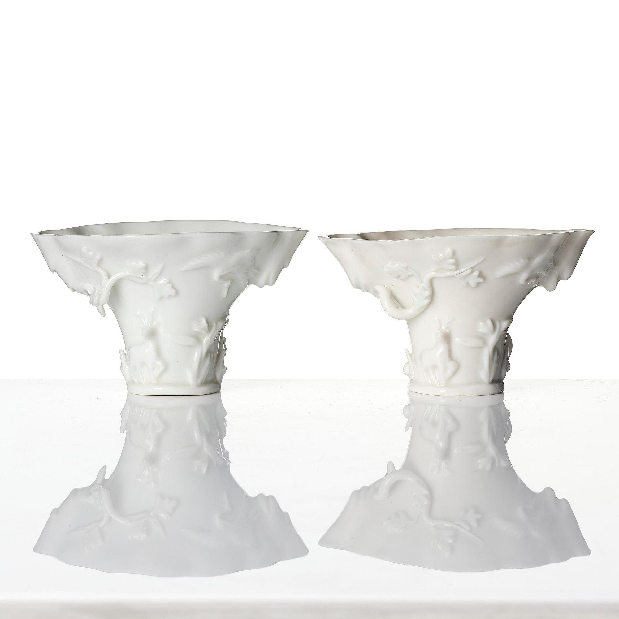 A pair of blanc de chine rhinoceros libation cups, Qing dynasty, Kangxi (1662-1722).