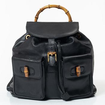 Gucci, A black leather backpack.