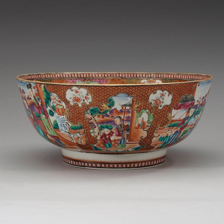 A large famille rose punch bowl, richly decorated with palace scenes, Qing dynasty, 18th century.