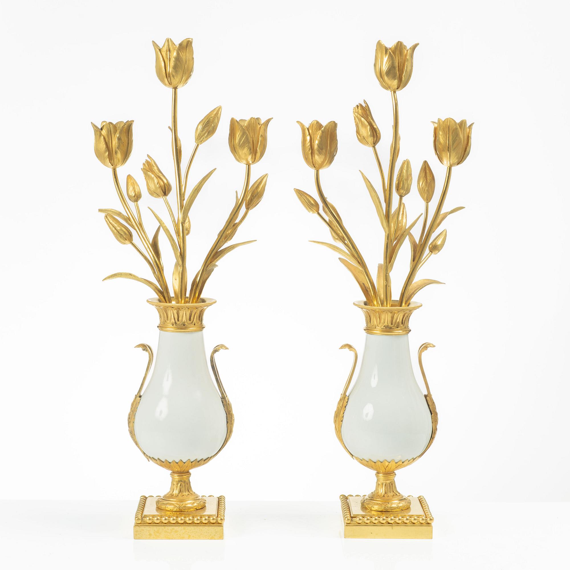 A pair of three light porcelain and gilt bronze three-branch Louis XV-style candelabra, mid 19th century.