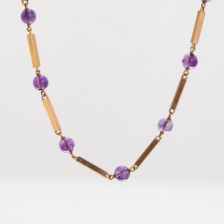 An 18K gold necklace, consisting of gold bars and amethyst beads.