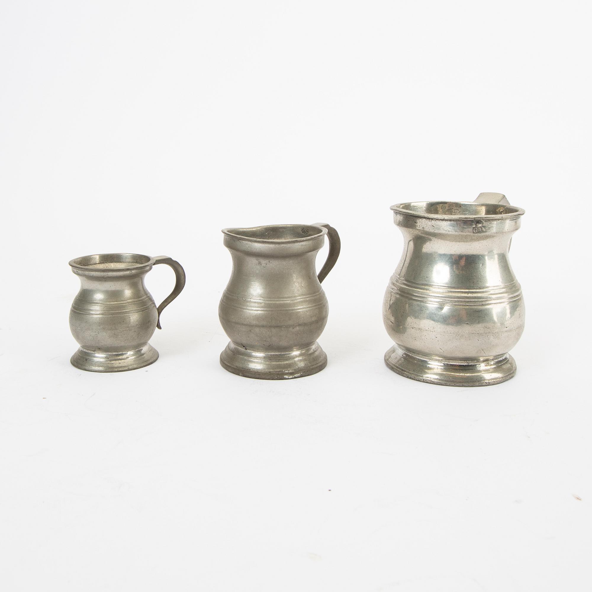 A set of five pewter tankards and six bowls England 20th century.