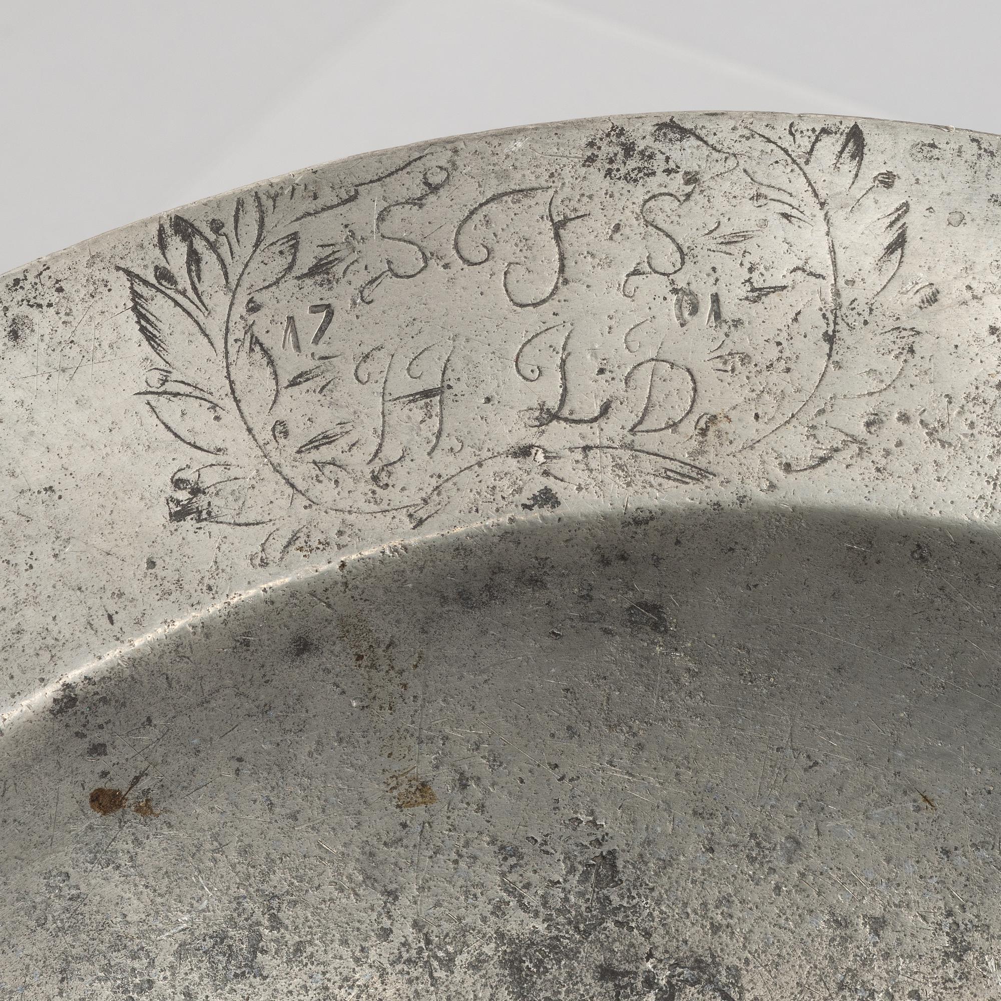 A large pewter charger, Sweden, dated 1701.