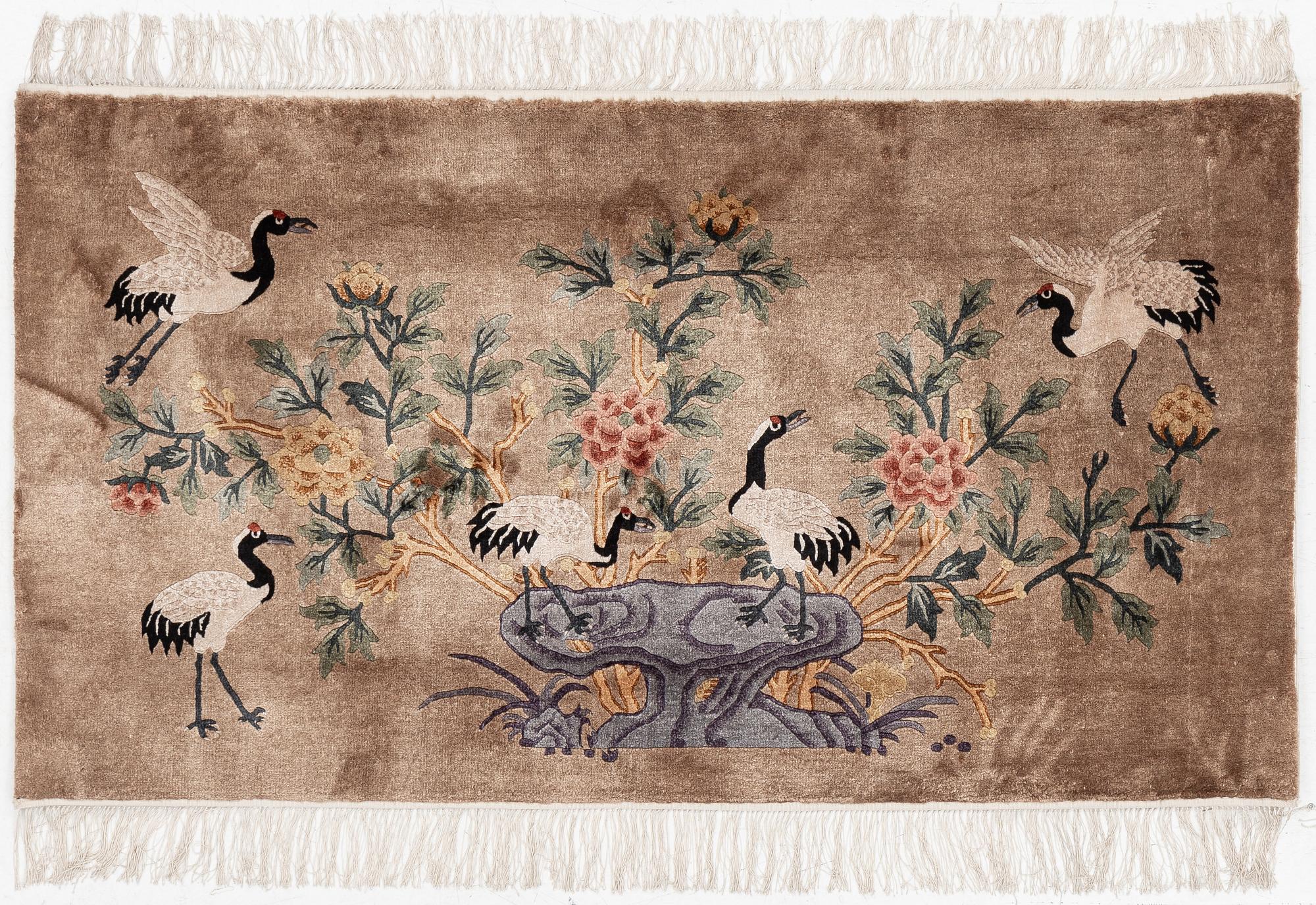 A silke figural rug, China, later part of the 20th century, ca. 92 x 170 cm.