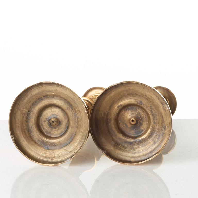 A pair of French Empire early 19th century gilt bronze candlesticks.