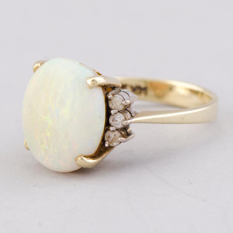 A RING, cabochon cut opal, brilliant cut diamonds, 14K gold.