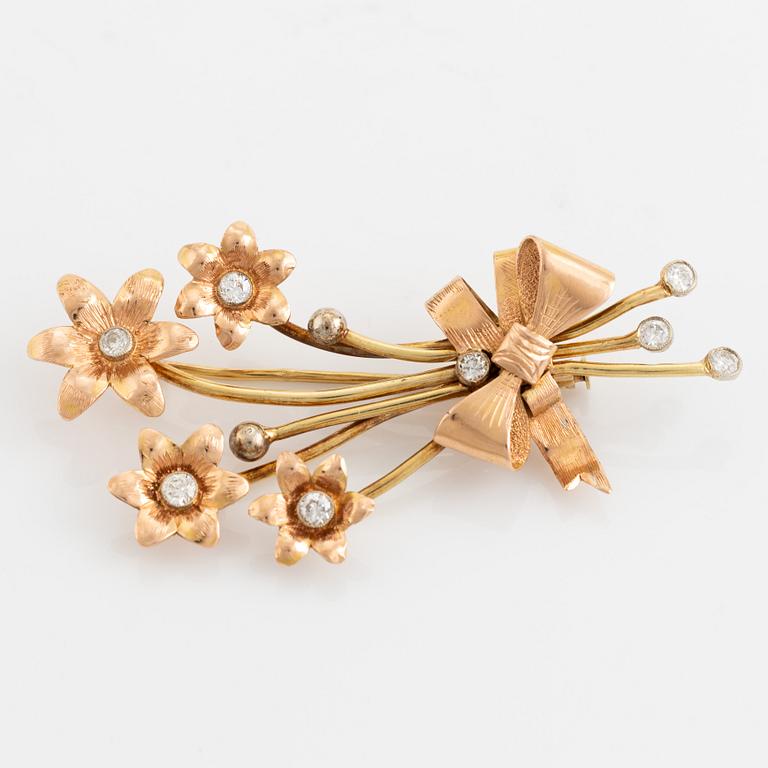 Gold and brilliant cut diamond flower brooch.