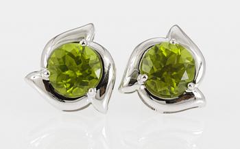 658. EARRINGS, set with peridotes.