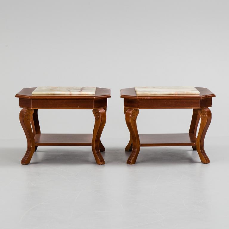 a pair of mahogany and marble tables from the late 20th century.