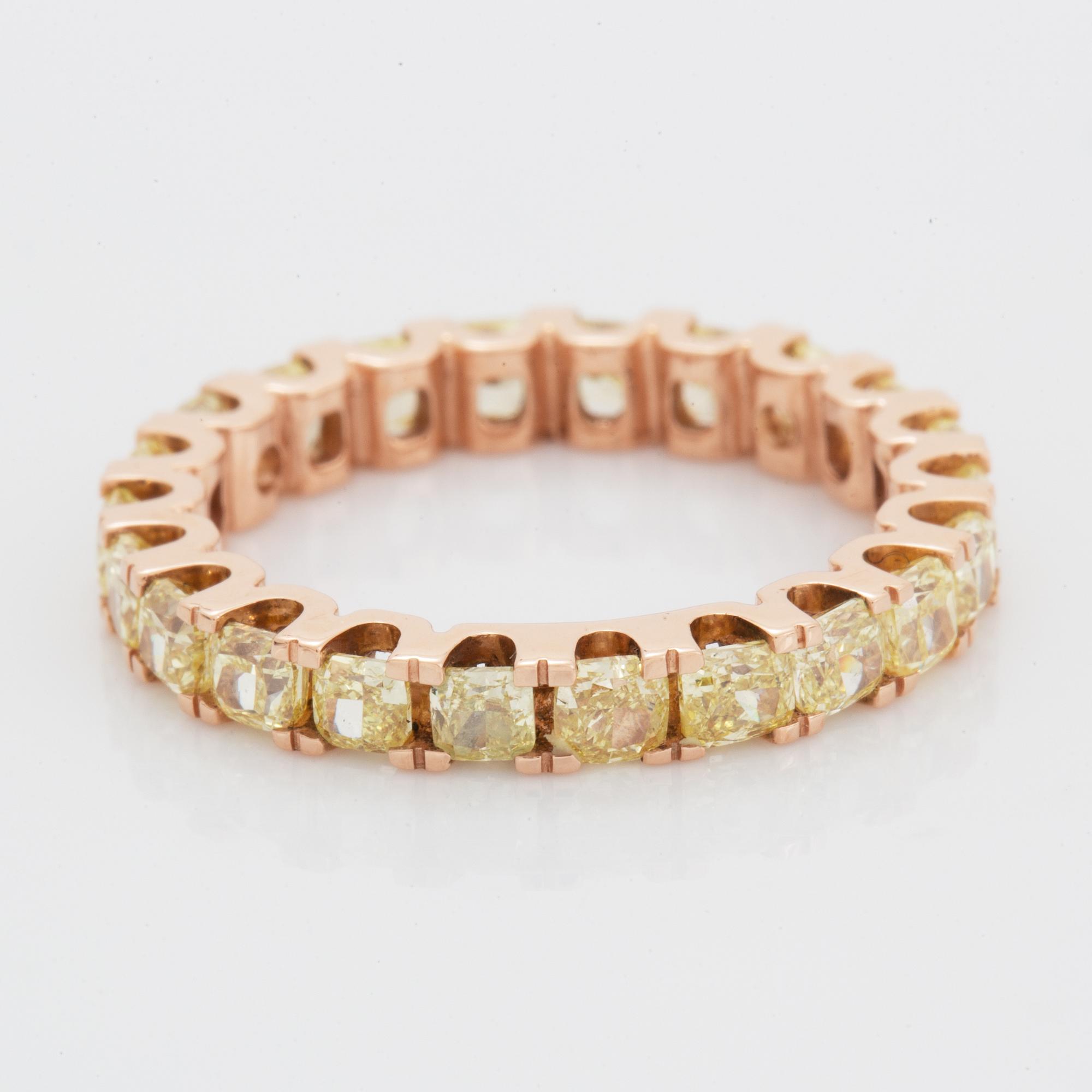 Cushion-cut yellow diamond eternity ring.