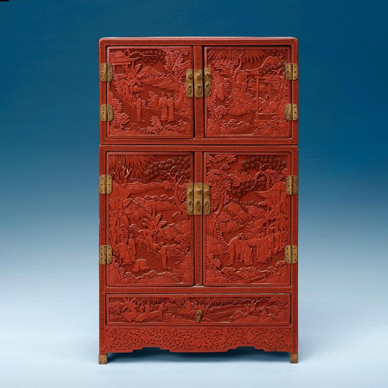 A well carved Cinnaber lacquer 'Kang'Cabinet, Qing dynasty, 18/19th Century.