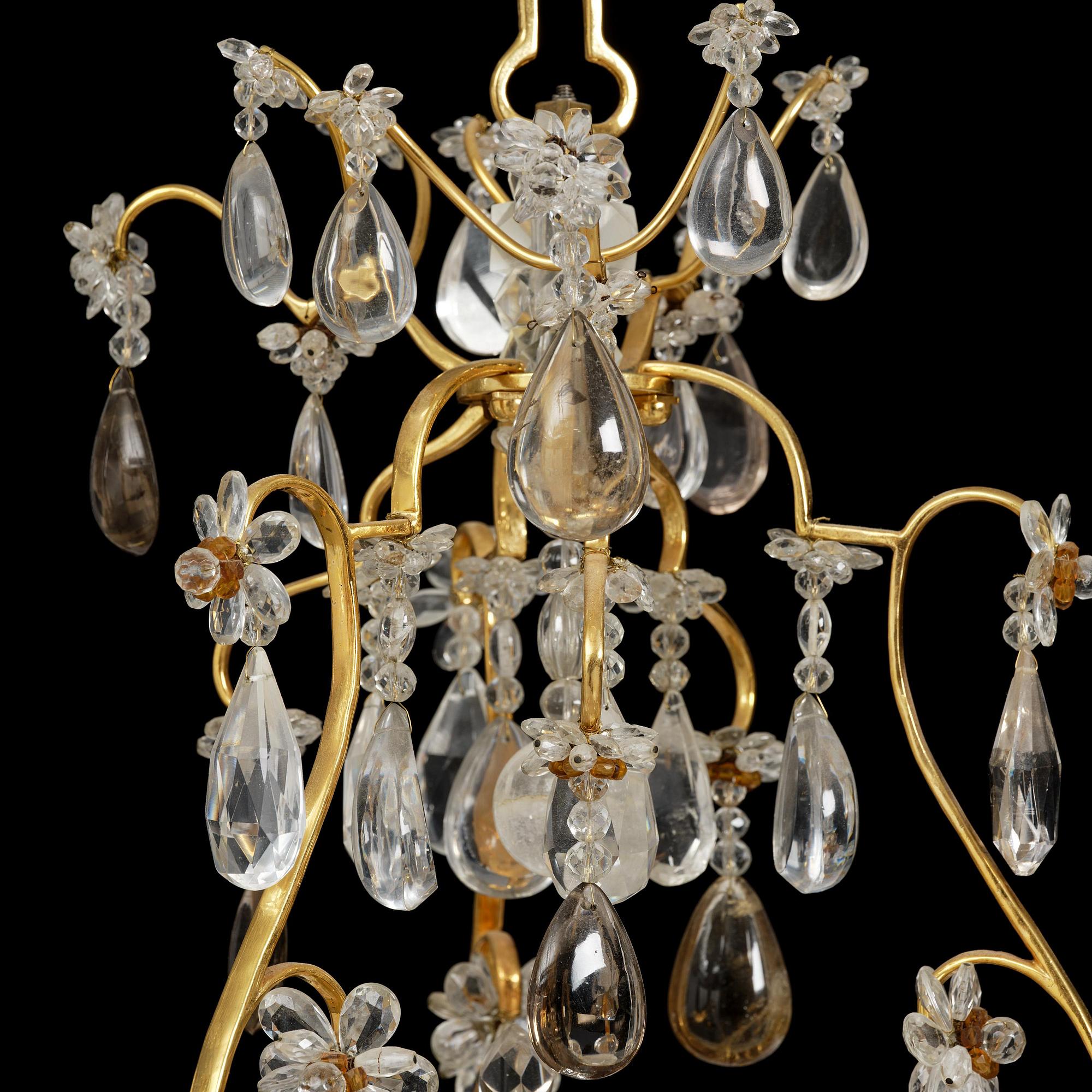 A near pair of Franch Louis-XV-style nine-branch gilt bronze and rock crystal chandeliers, later part 19th century.