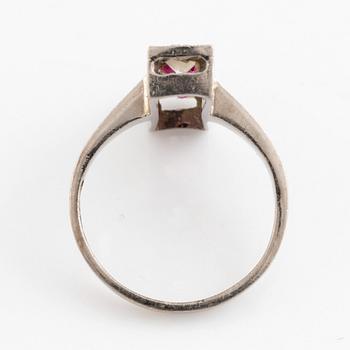 An 18K white gold ring set with faceted rubies and old-cut diamonds.
