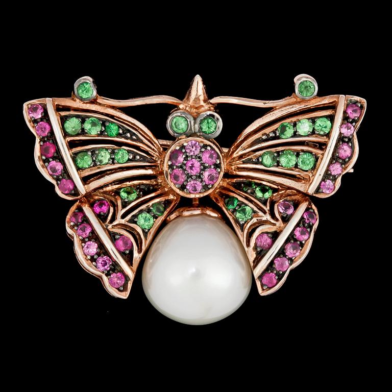 A butterfly brooch set with pink sapphires, tsavorites and cultured fresh water pearl.