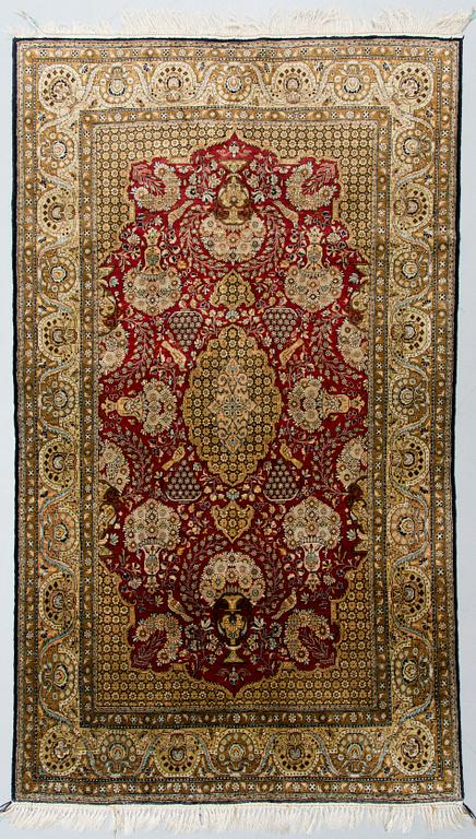 An oriental silk rug. Circa 188x106 cm.