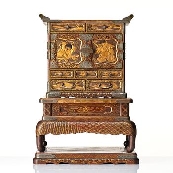 A Japanese lacquer cabinet on a stand, Meiji period (1868-1912).