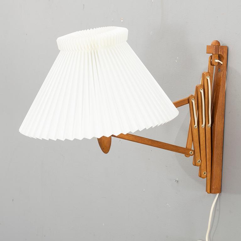 A teak wall lamp by Erik Hansen, Le Klint, Denmark.